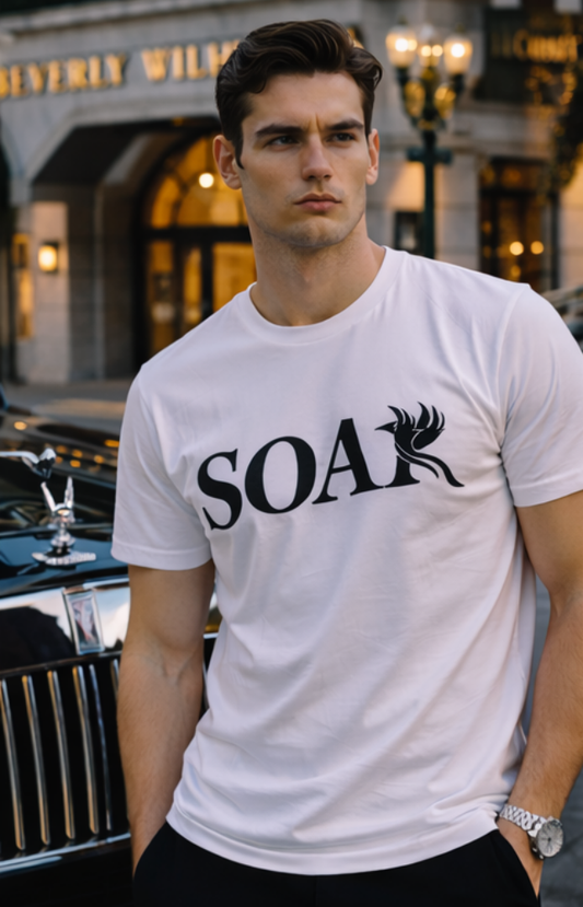 Male model wearing SOAR white premium cotton t-shirt with black logo in upscale city setting
