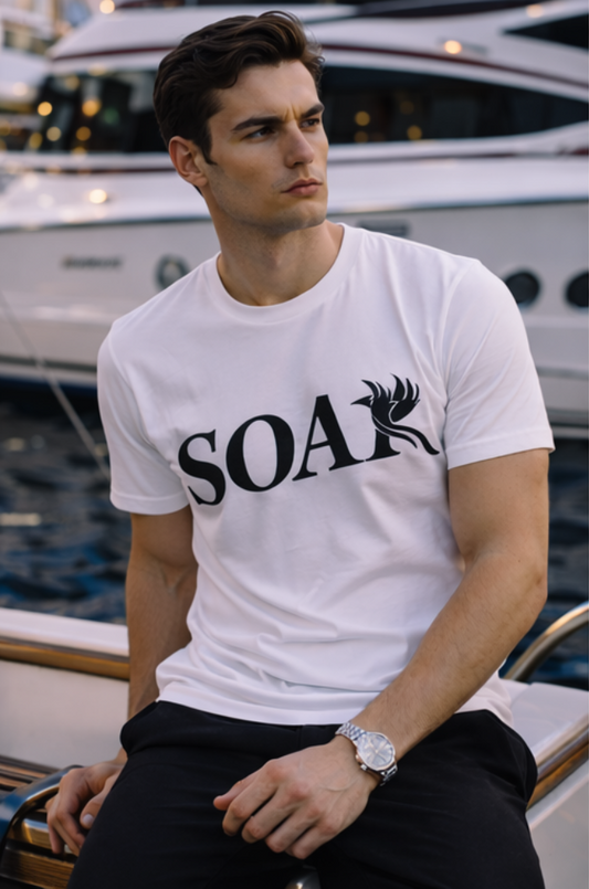 Male model wearing SOAR Essential white t-shirt with black logo in luxury marina setting